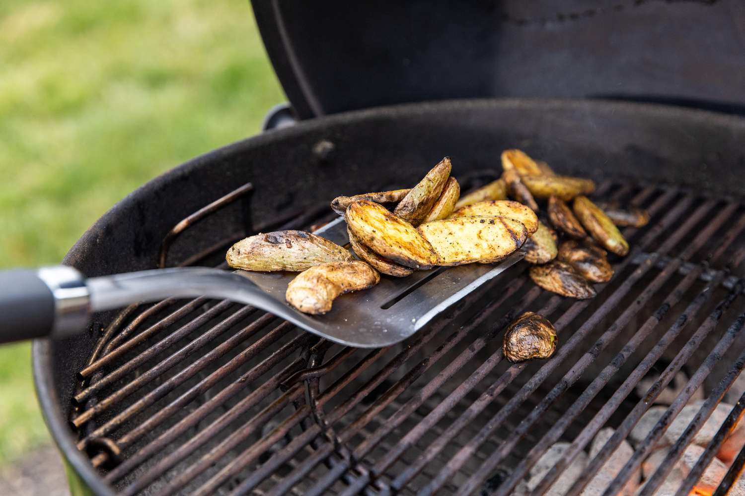 Spatula Used to Remove Grilled Potatoes from Grill