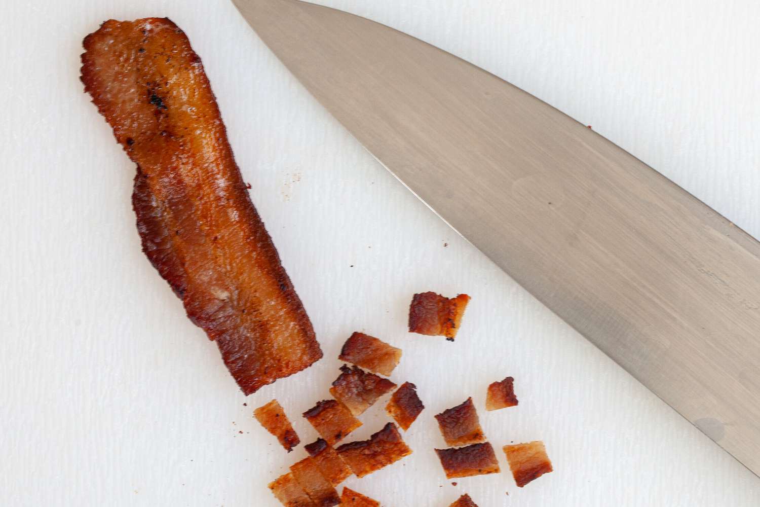 Chopping bacon for a turkey breast recipe.