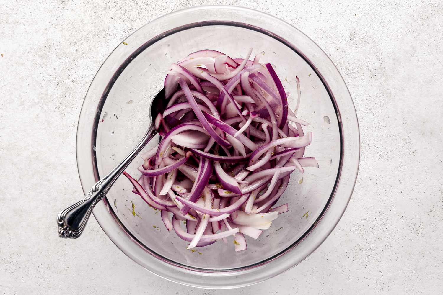 Quick Pickled Red Onion Slices in a Bowl with a Spoon for Roasted Sweet Potato Salad Recipe