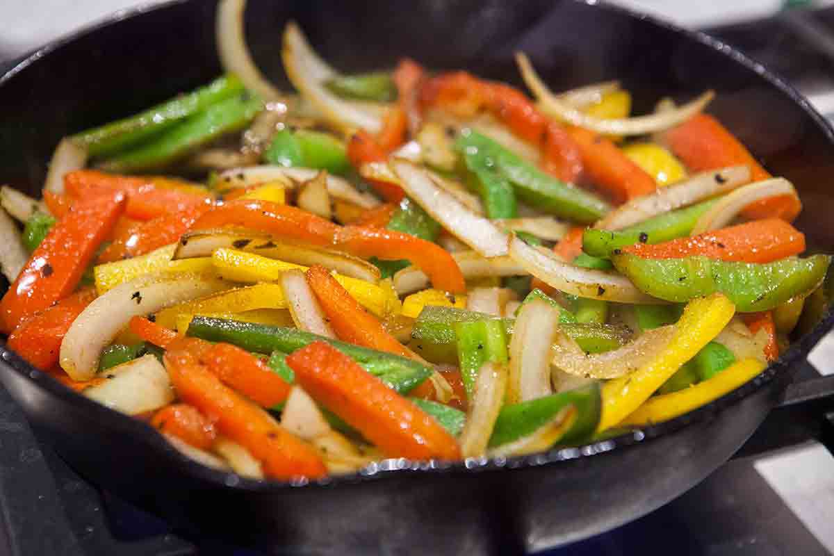 sear peppers and onions for fajitas in cast iron pan