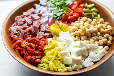 Large Bowl of Cheese, Peppers, Salami, Olives, Chickpeas, and Lettuce for Italian Chopped Salad 