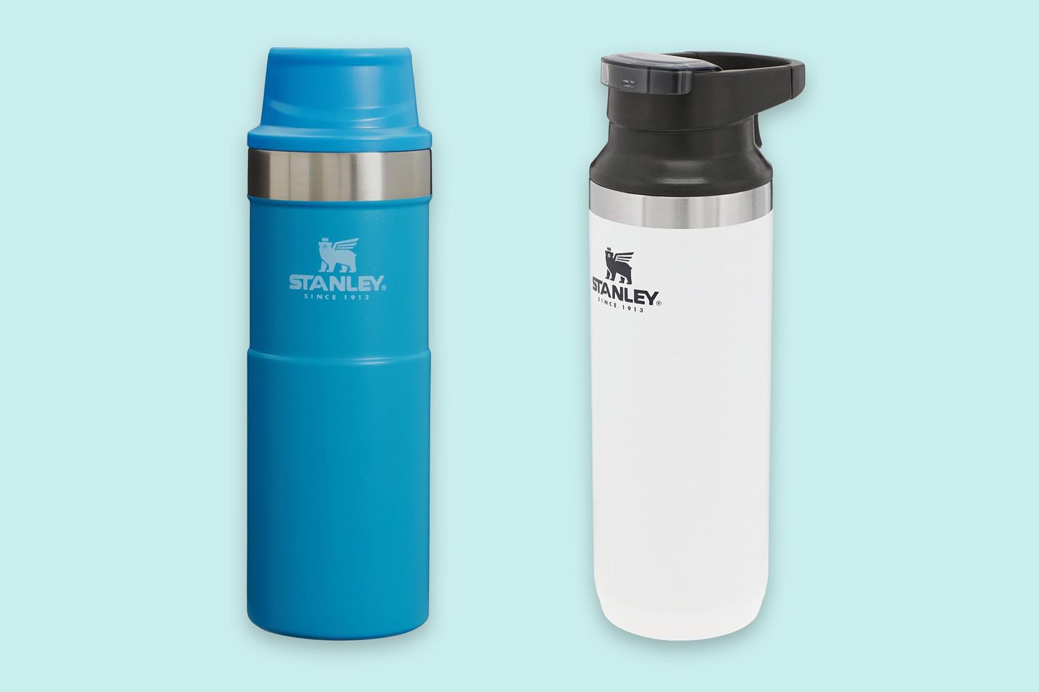 A blue Stanley mug and a white Stanley mug with a black lid