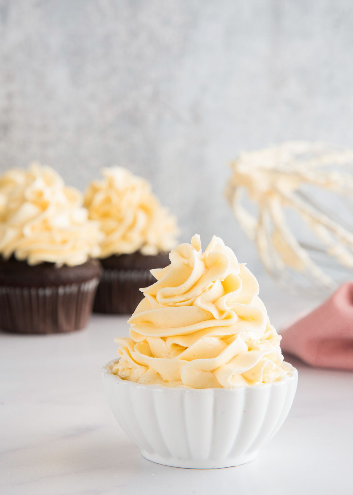 French meringue buttercream piled high in a small bowl.