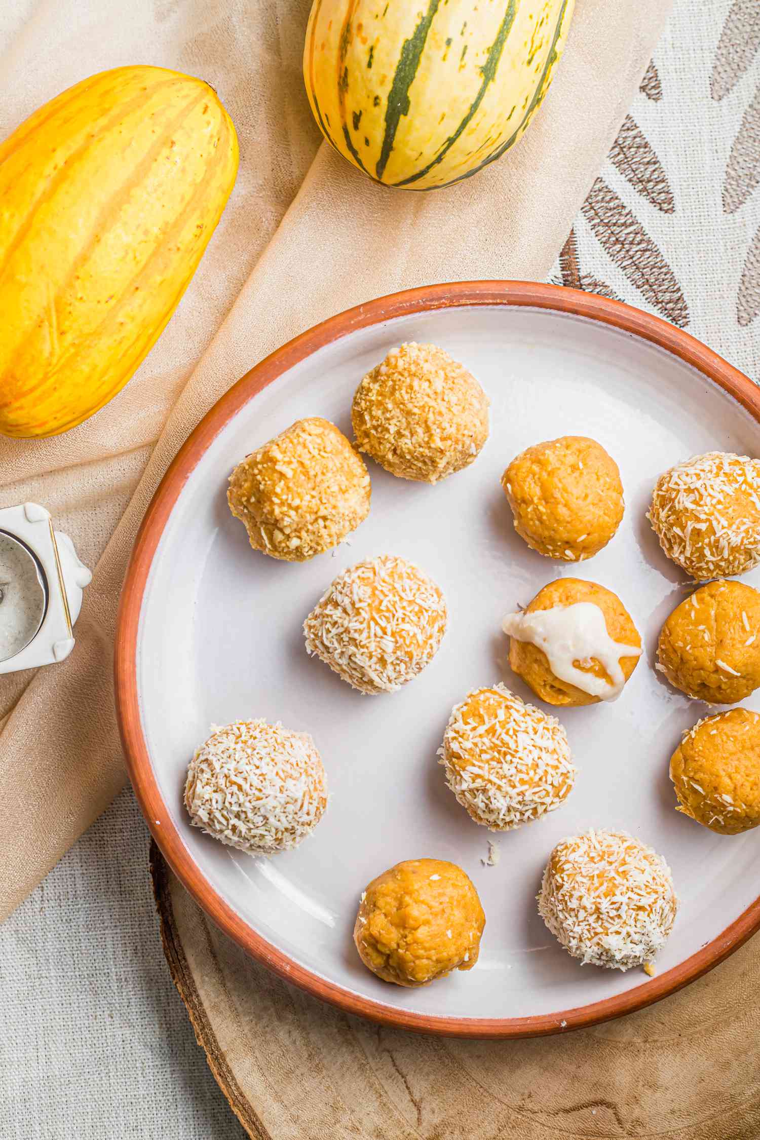 Pumpkin Ladoo on a Plate Next to Delicata Squash