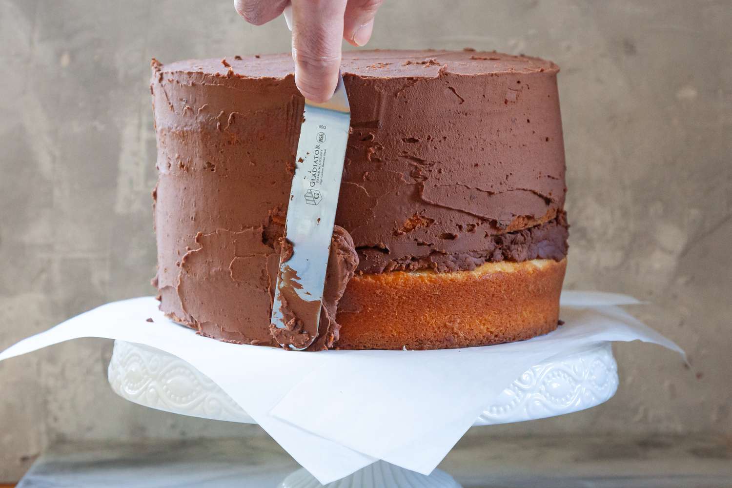 Showing a Cake Frosting Technique using chocolate frosting.