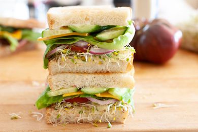Loaded Veggie Sandwiches Stacked on a Cutting Board