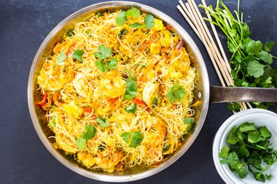 Singapore Rice Noodles Recipe with shrimp and cilantro in a skillet