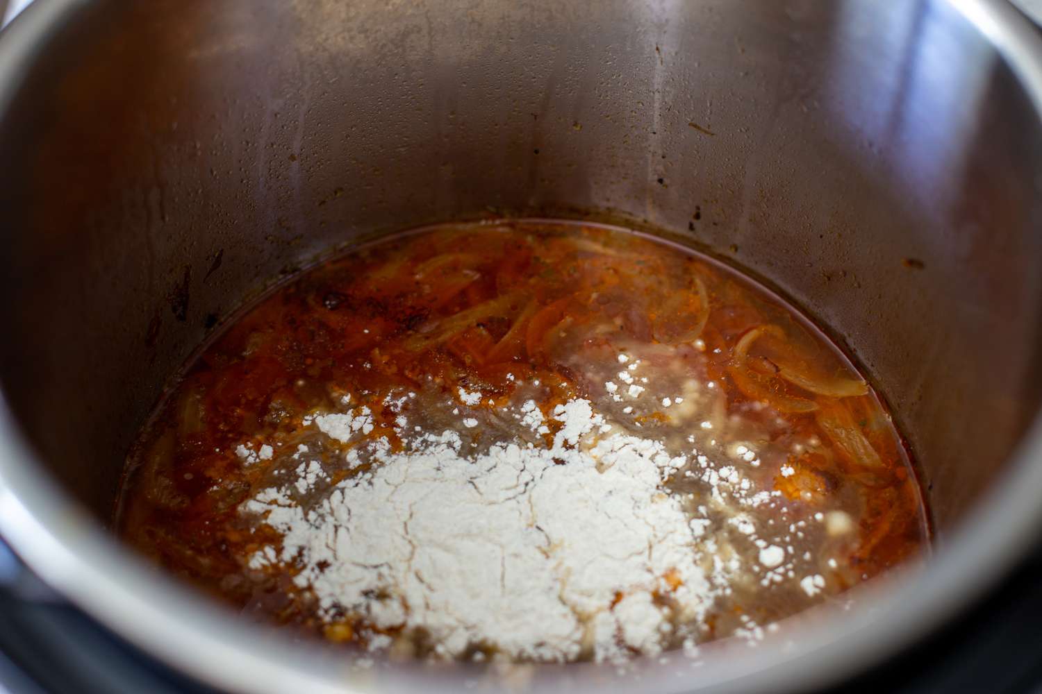 Adding flour to liquid in an instant pot to make gravy.