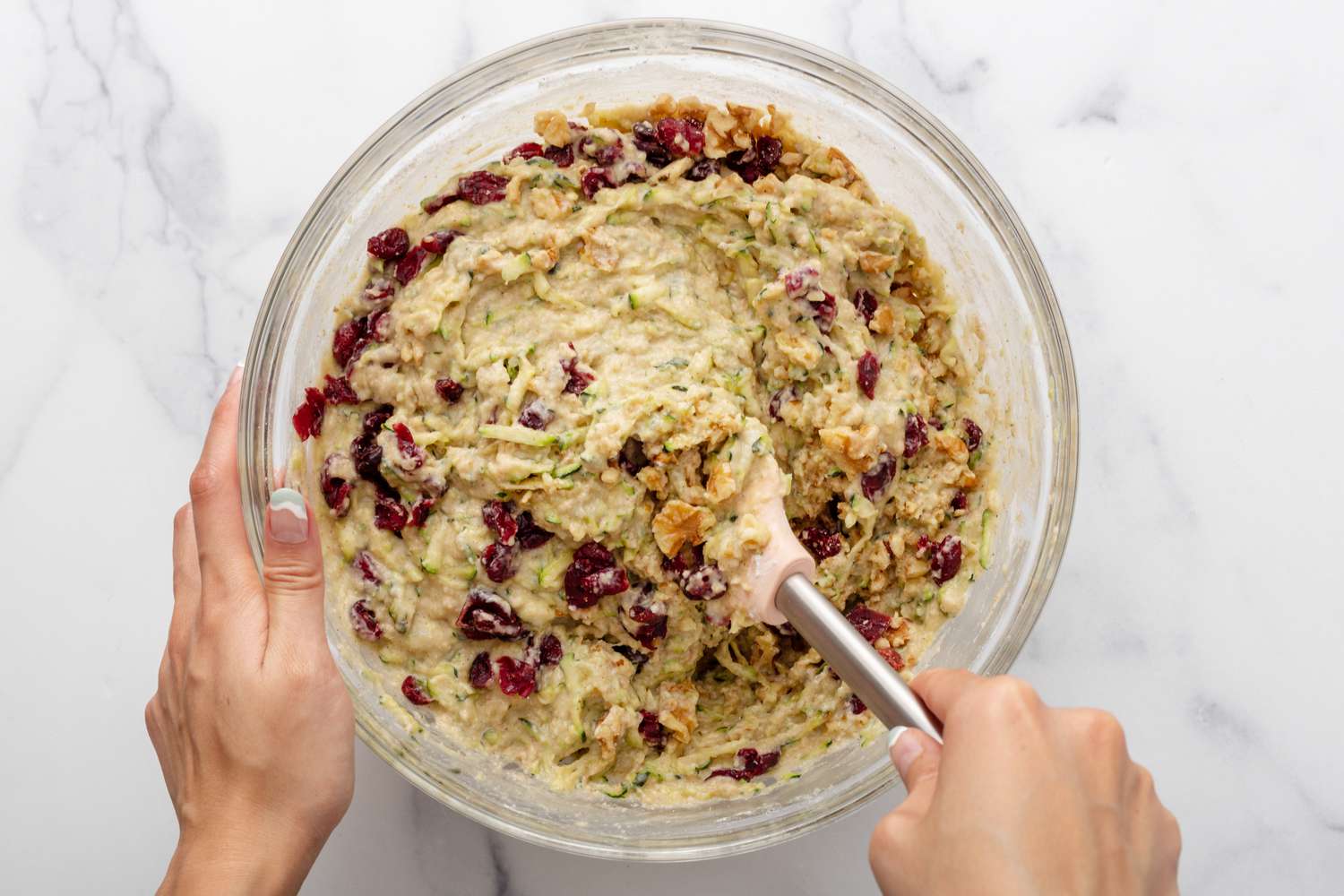 Mixing cranberries into zucchini batter