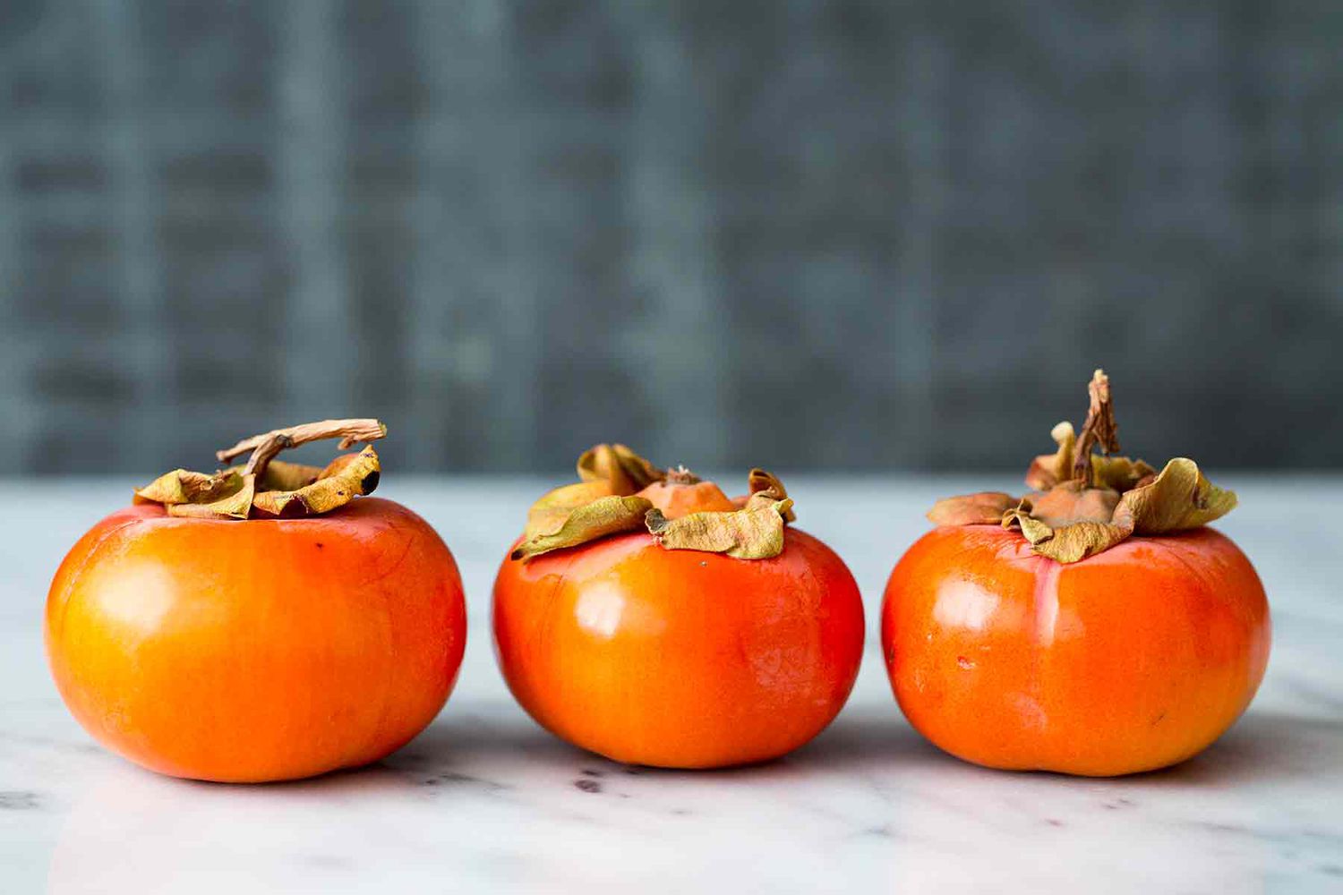 Fuyu Persimmons look like squat orange tomatoes