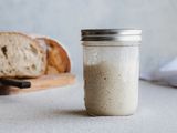 Side view of a mason jar filled with a simple sourdough starter