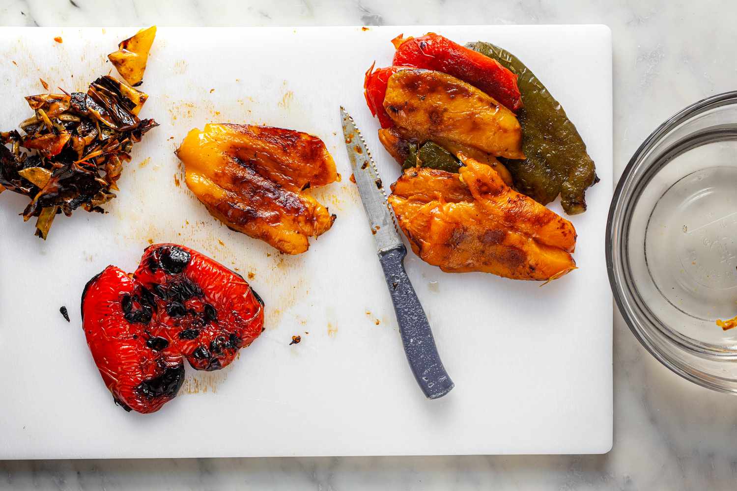 Removed Charred Skins from Grilled Peppers on Cutting Board