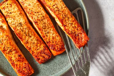 Cooked salmon fillets on a plate with a spatula
