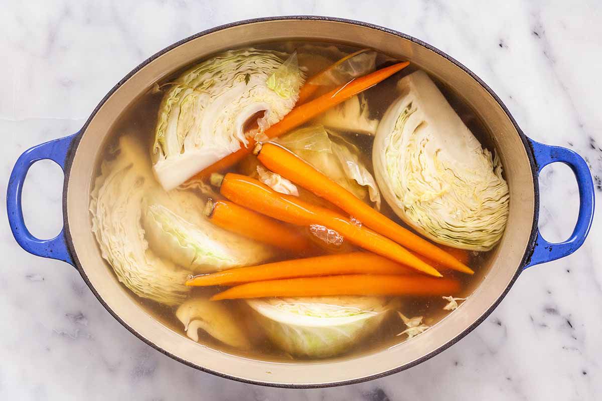 How to Make Corned Beef and Cabbage - cabbage, carrots and potatoes in a pot