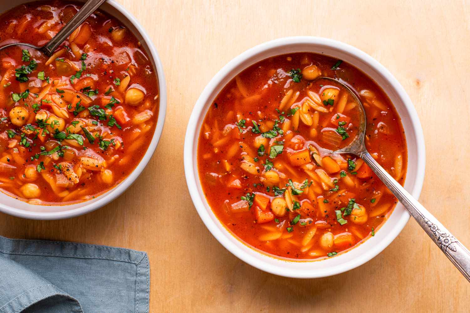 overhead view of 2 bowls of 20-Minute Tomato Orzo Soup