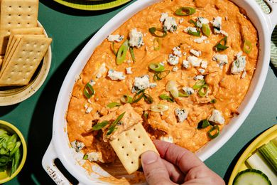 A close-up of a casserole dish filled with delicious-looking chicken dip.