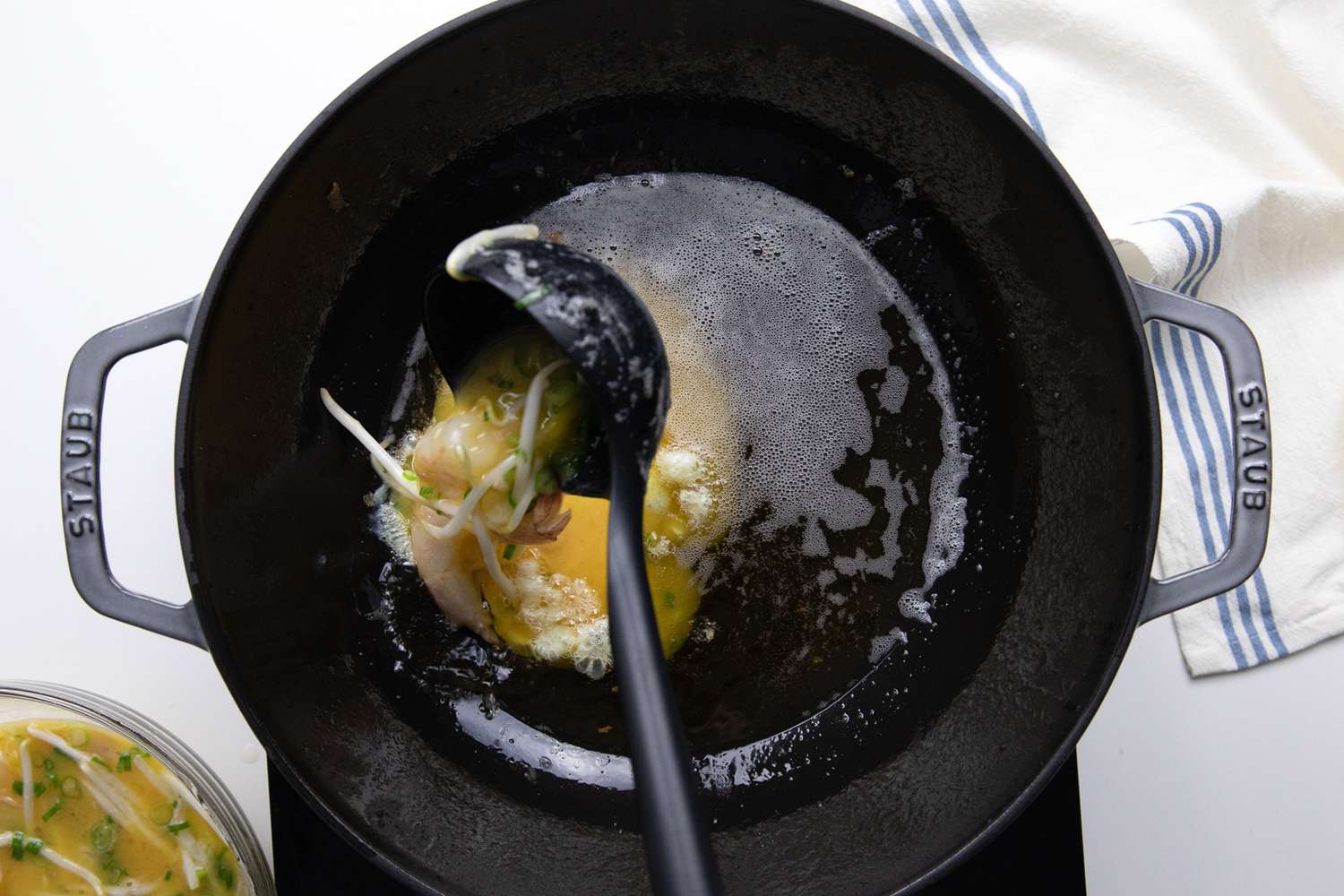 Egg Foo Young Carefully Ladled into Wok with Hot Oil 