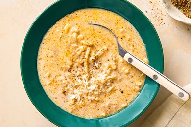 Bowl of creamy cacio e pepe potato soup with a spoon