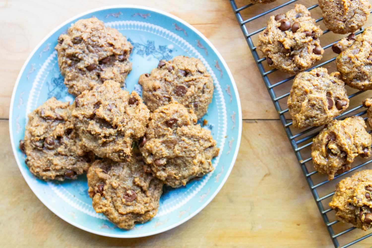 Plate of cookies next to cooling rack with more cookies
