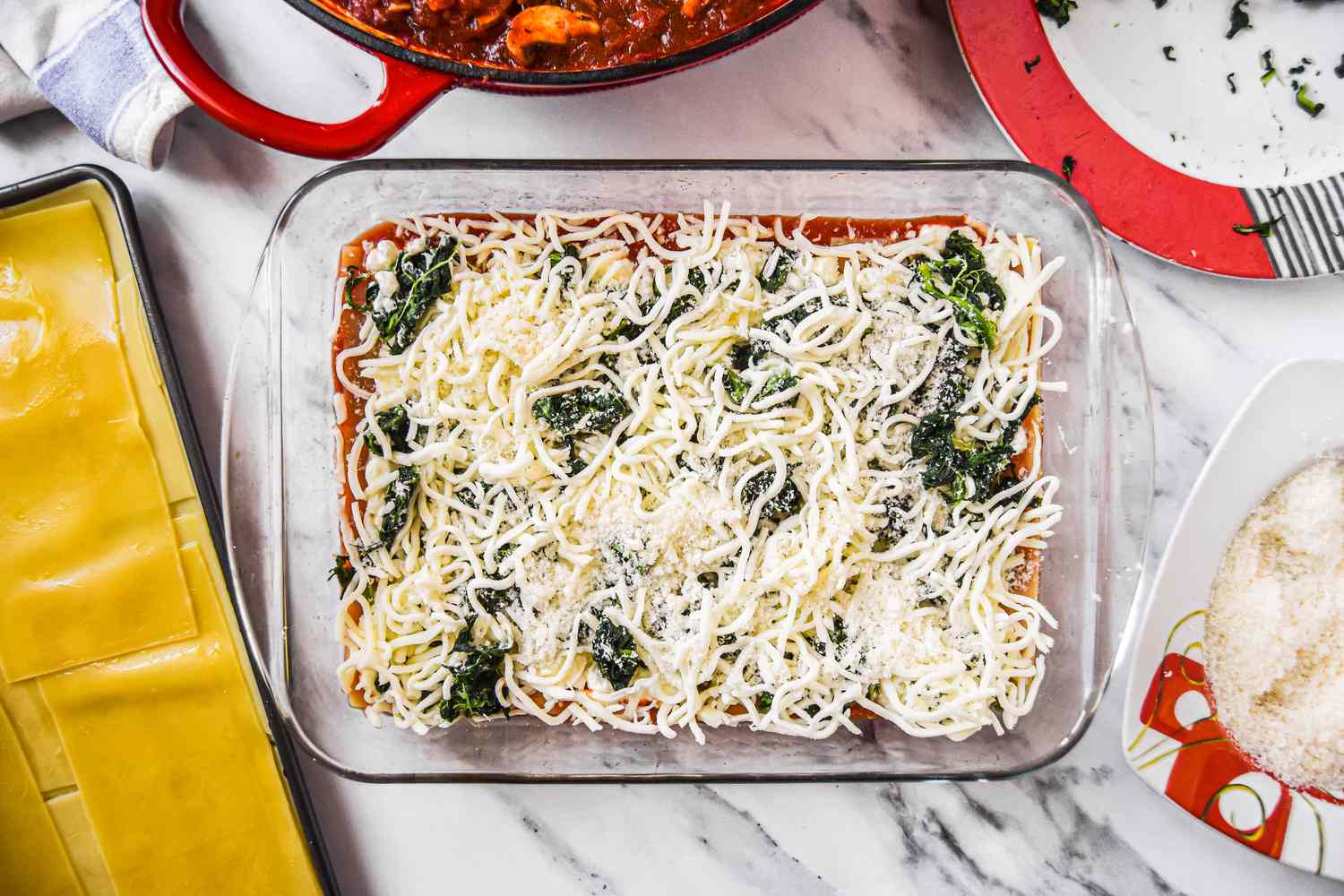 A Layer of Spinach and Cheese in a Casserole Dish placed on top of noodle layer