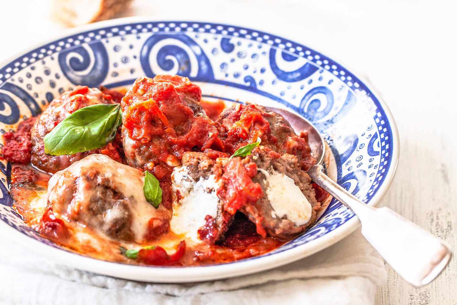 Pork and beef meatball recipe - blue and white bowl with meatballs and sauce