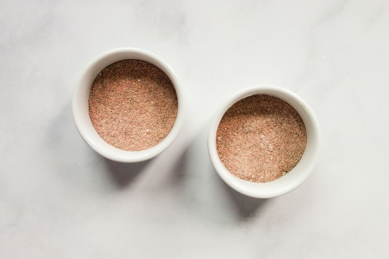 Two bowls of burrito casserole seasonings.