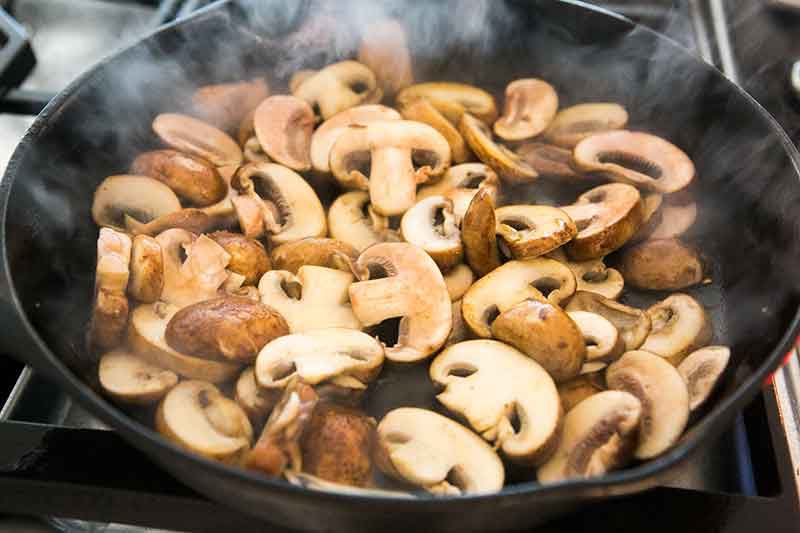 mushrooms sautéing in a pan
