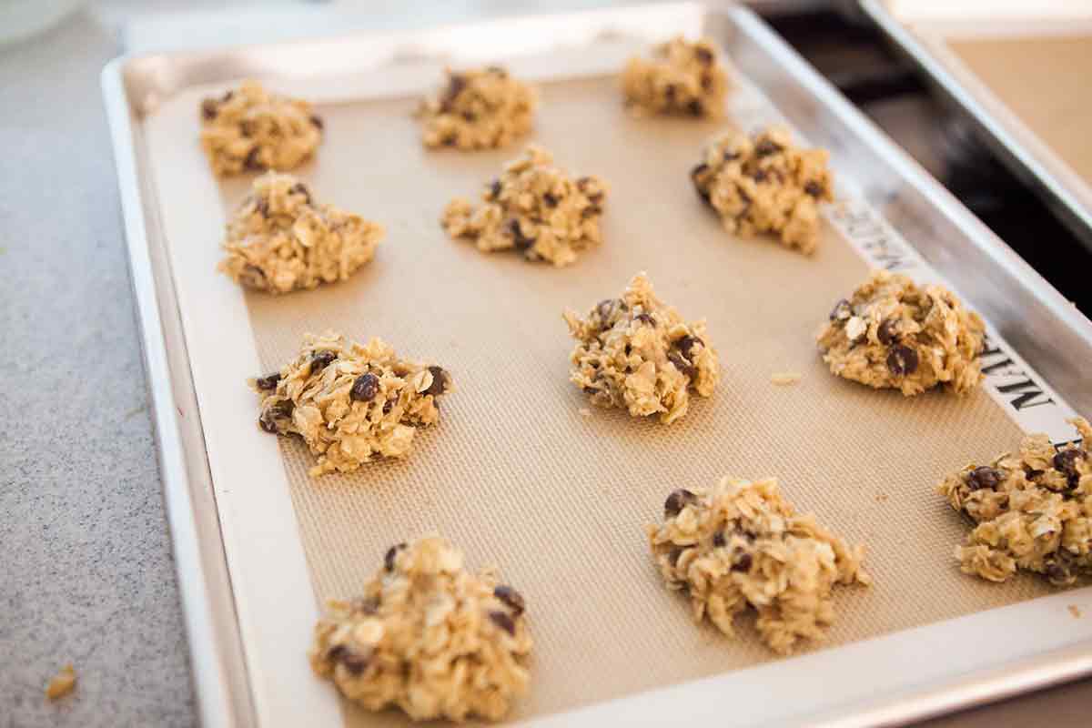 Oatmeal Chocolate Chip cookies scooped onto a baking sheet