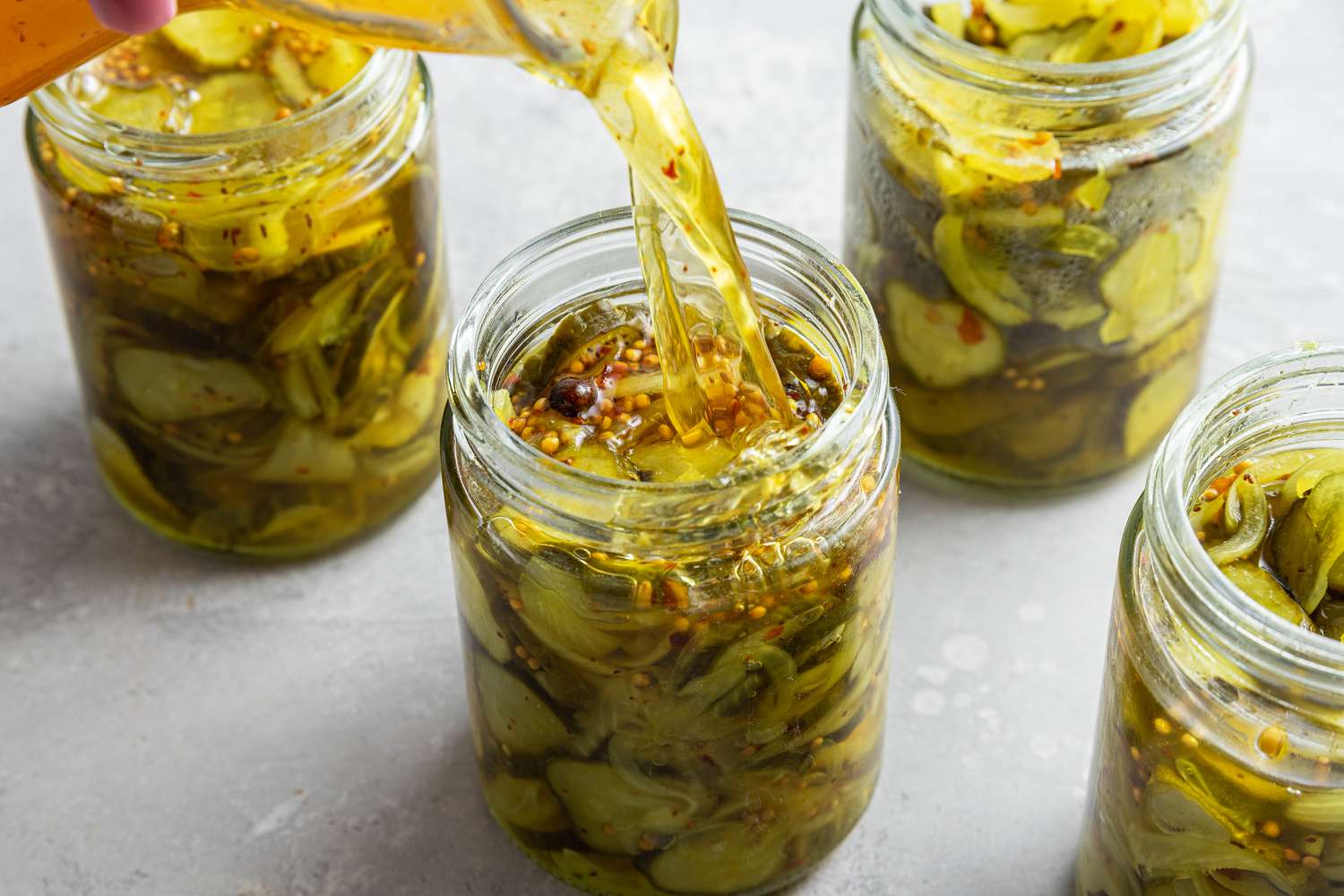 Brine Poured into Jars with Bread and Butter Pickles 