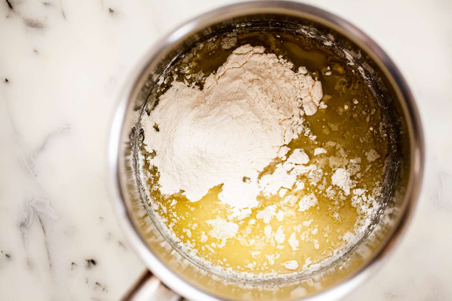 Add all purpose flour to melted butter for classic velouté sauce