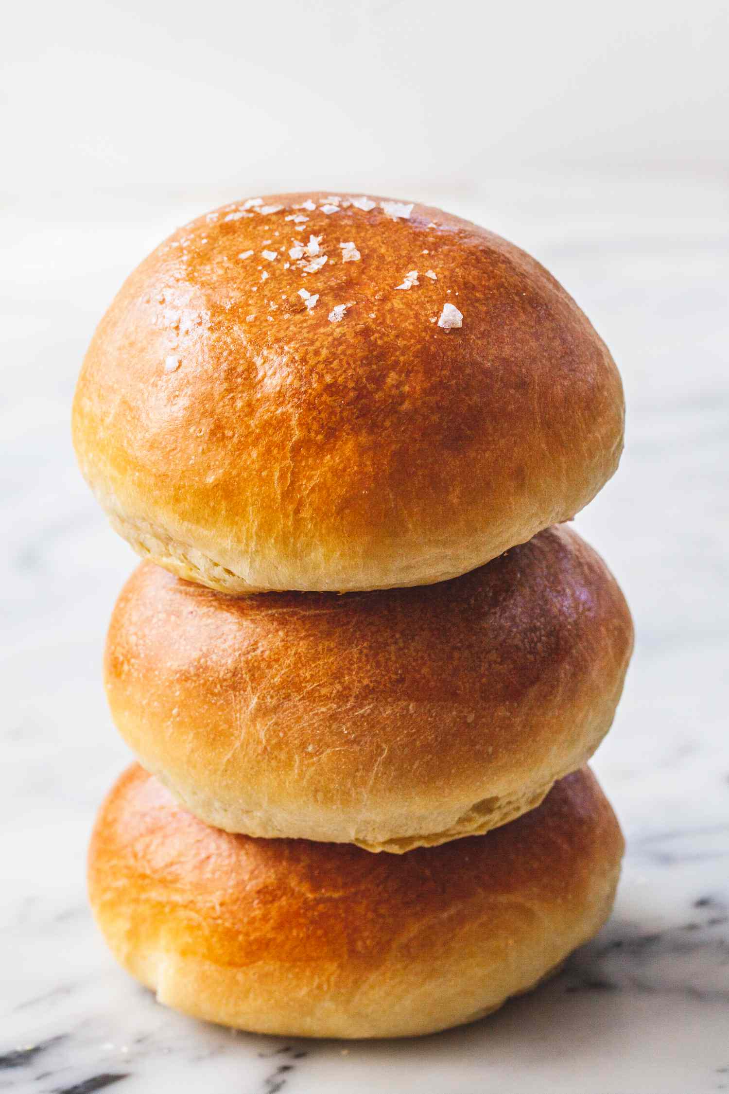 A stack of three homemade brioche buns.