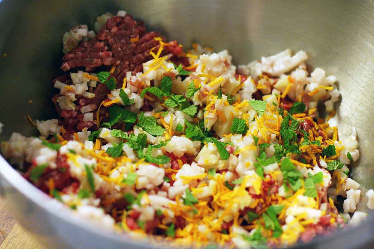 greek meatball ingredients in large mixing bowl