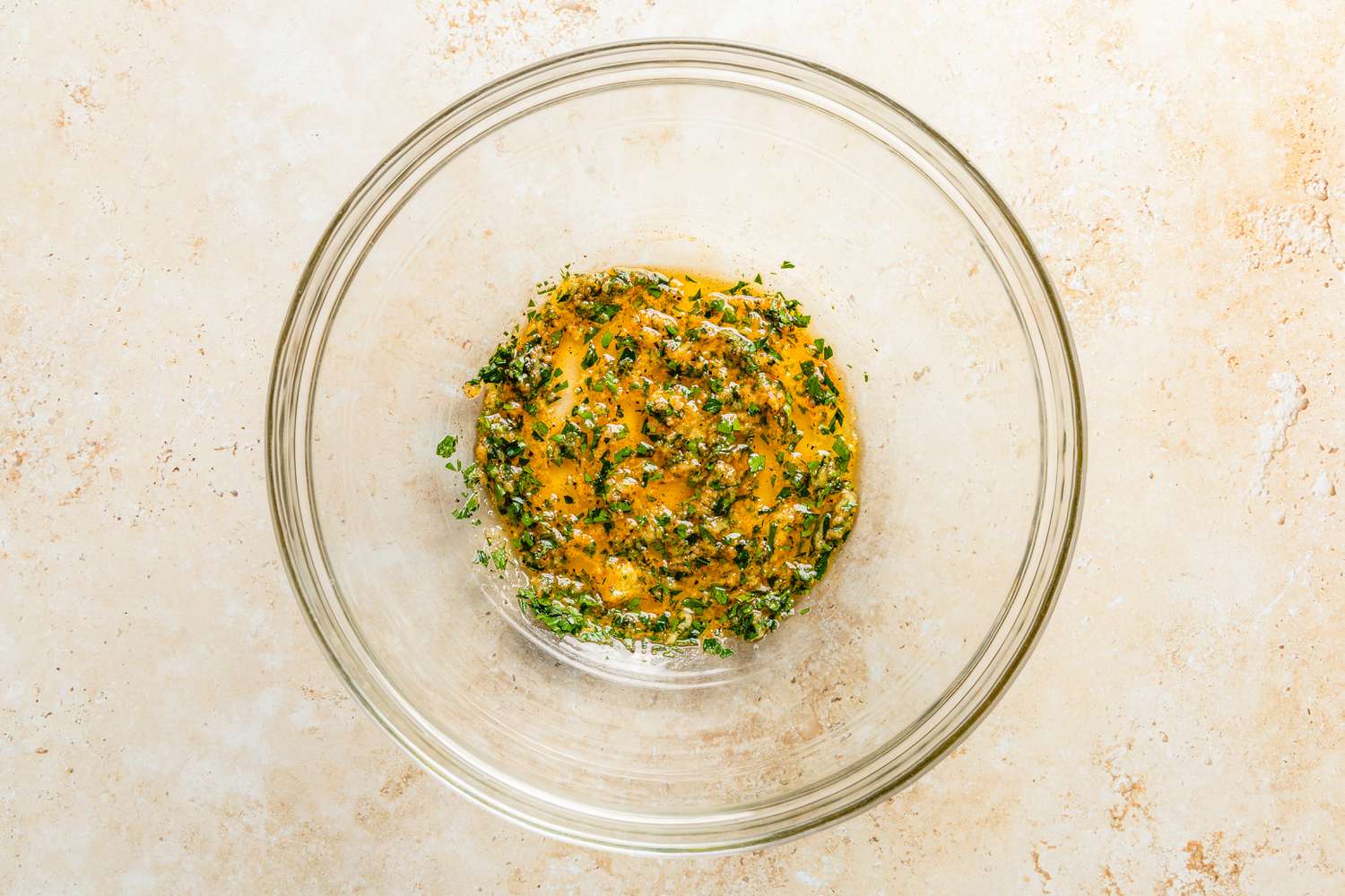 olive oil mixture in a bowl for crispy parmesan potatoes recipe