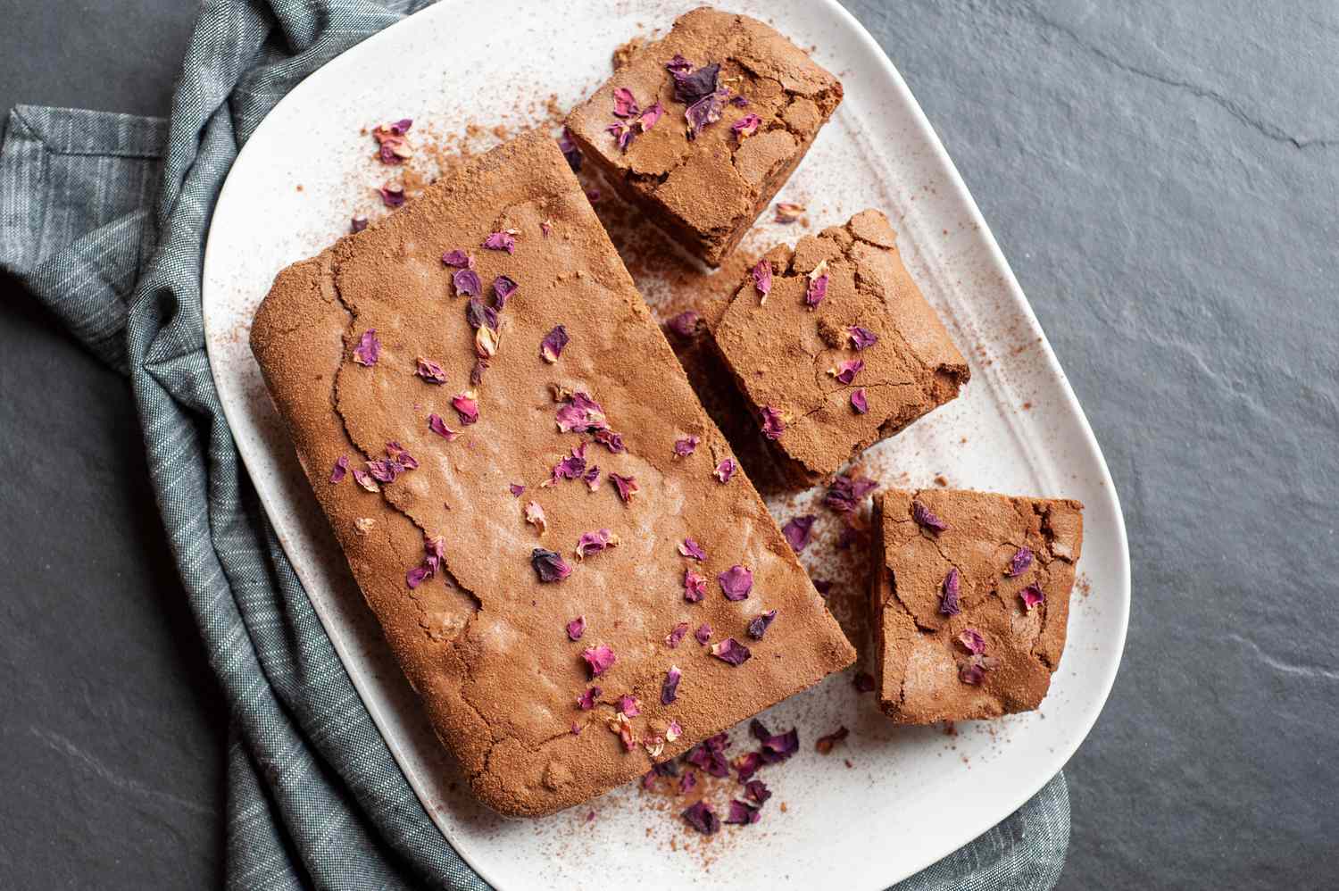 Spiced brownies on a white platter.