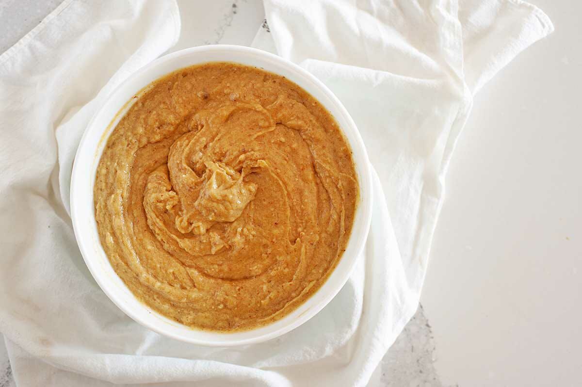 Batter for Healthy Pumpkin Bread in a white bowl.