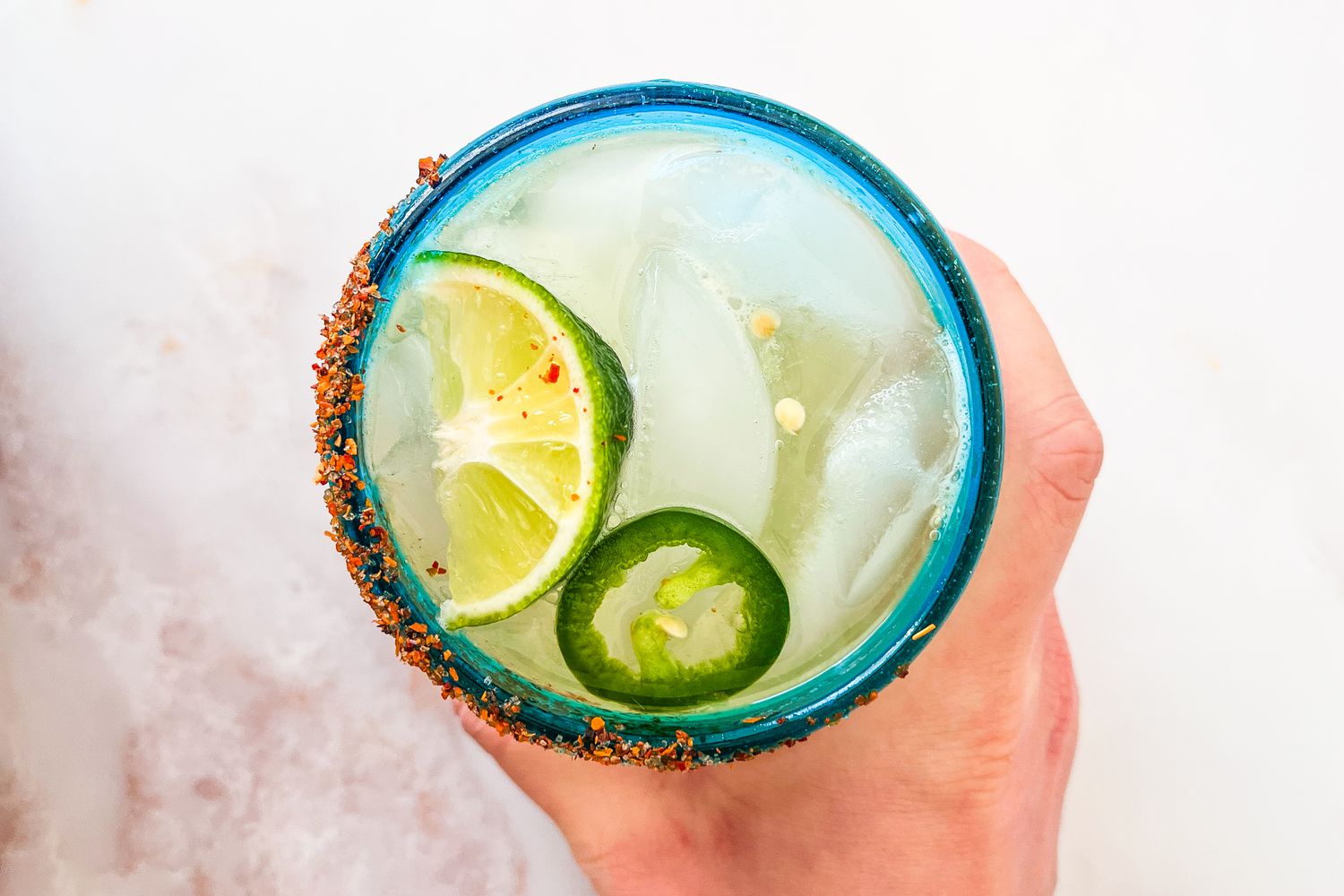 Hold handing a spicy margarita 