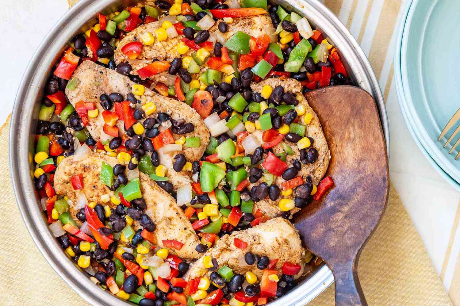 Easy Skillet Chicken - close up of chicken tenders with black beans, corn, and red and green bell peppers