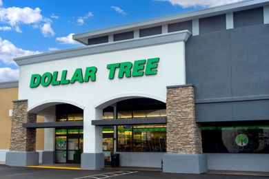 Exterior of a Dollar Tree store with green signage and a parking space in front