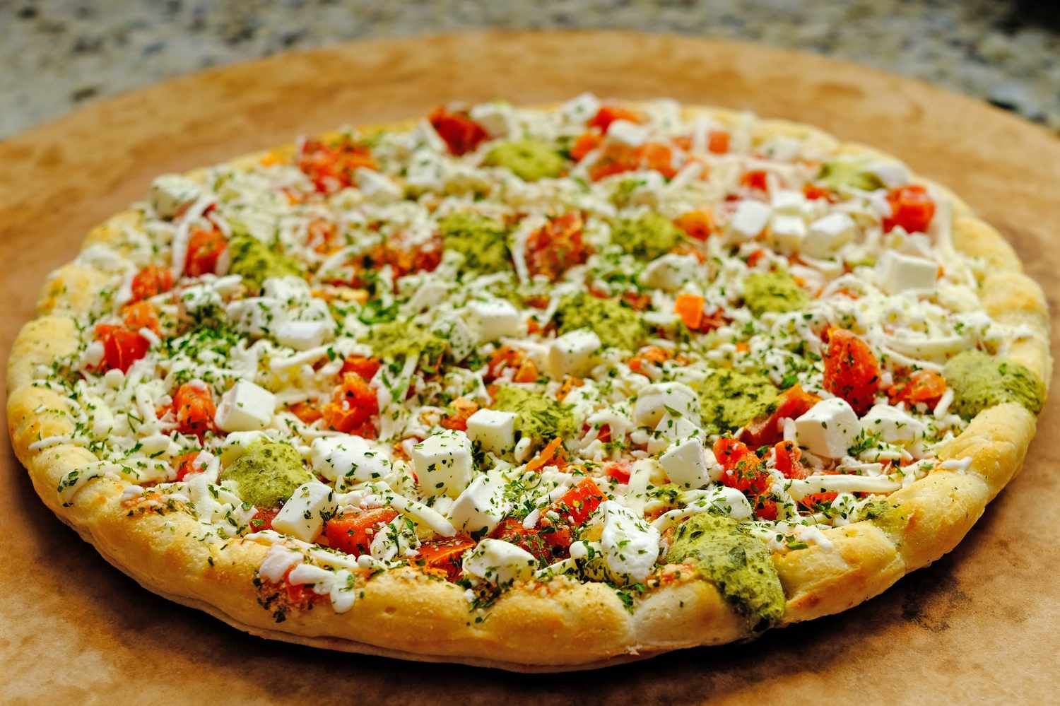 Frozen pizza with added toppings of pesto tomatoes and cheese enhanced for a recipe technique