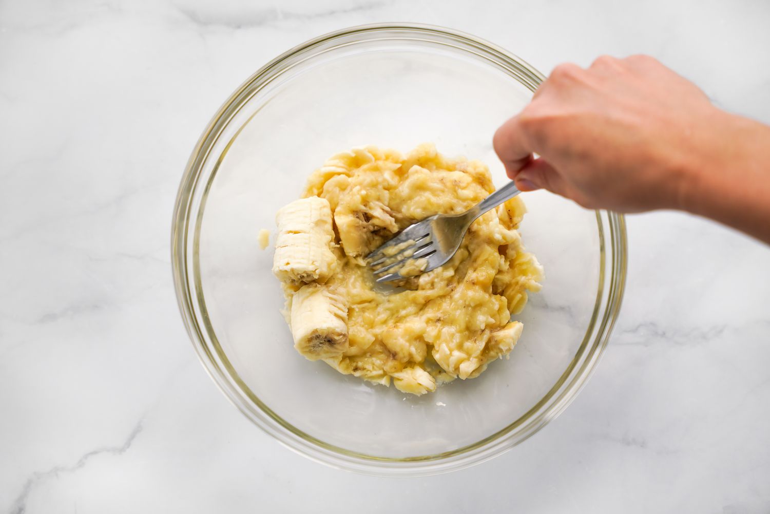 Bowl of Bananas Mashed with a Fork for Vegan Brownie Recipe