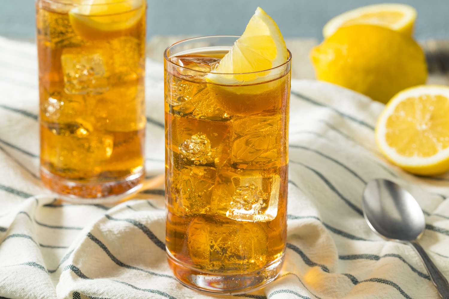 iced tea in glasses with ice and lemon wedges