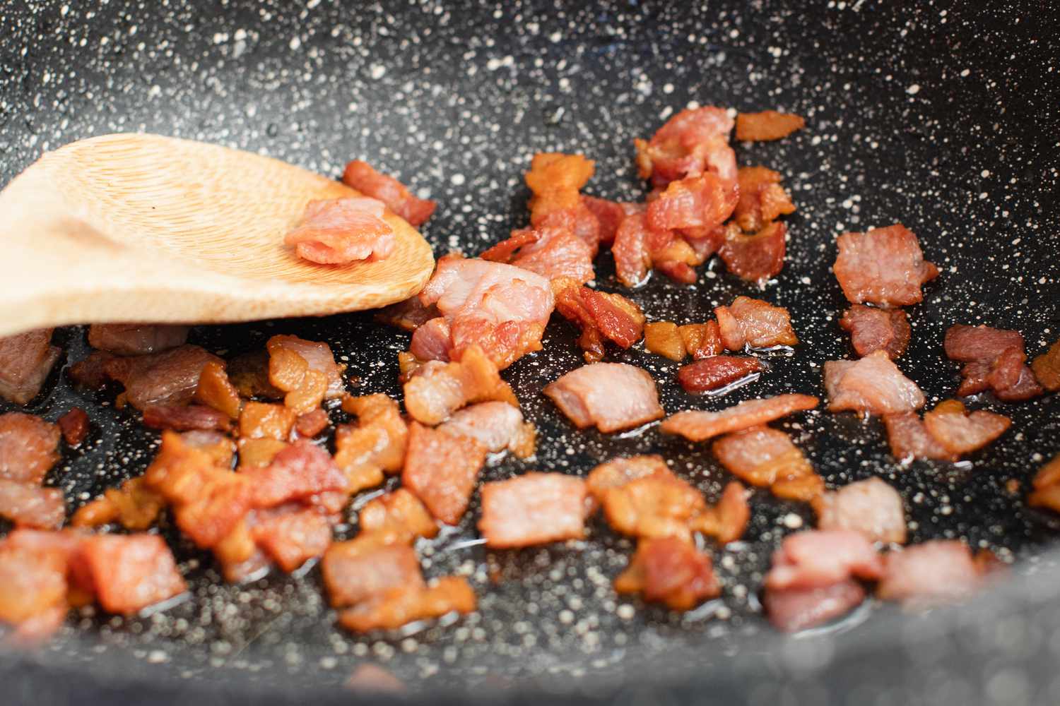 Cooking bacon to show how to make dirty rice.