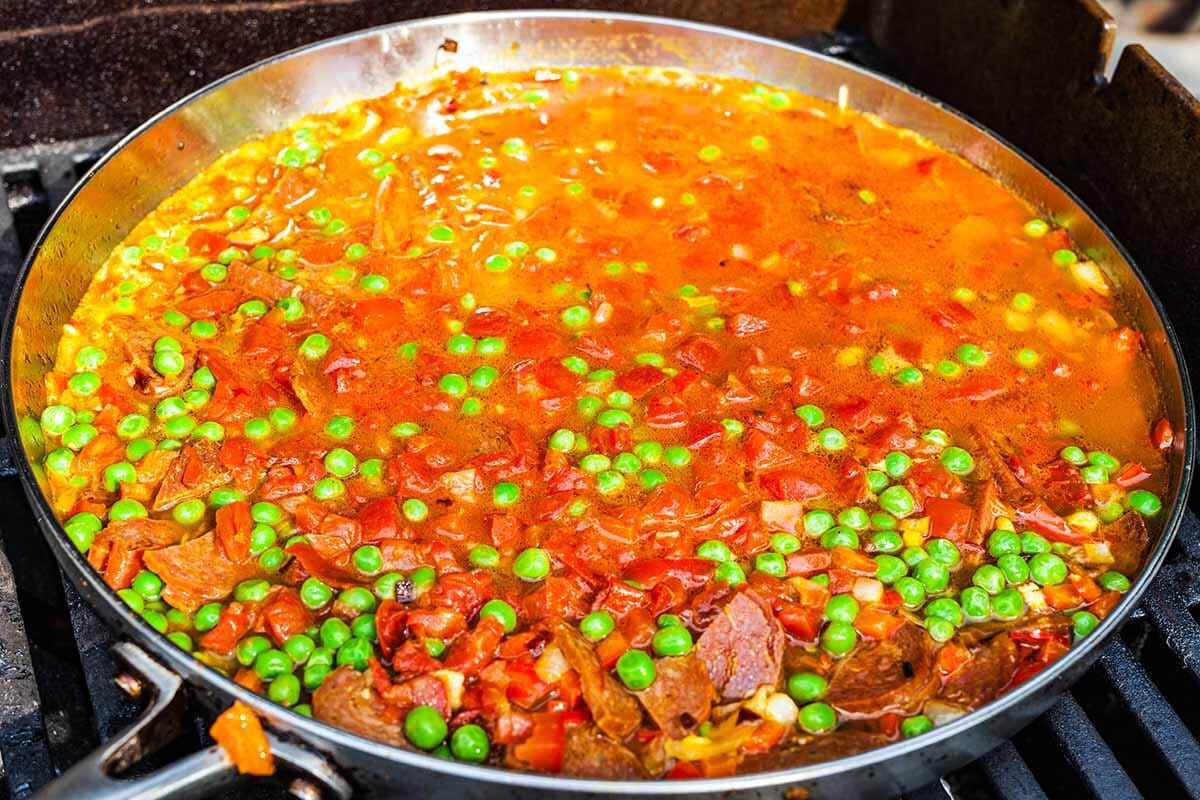 Seafood paella cooking until the rice absorbs the stock
