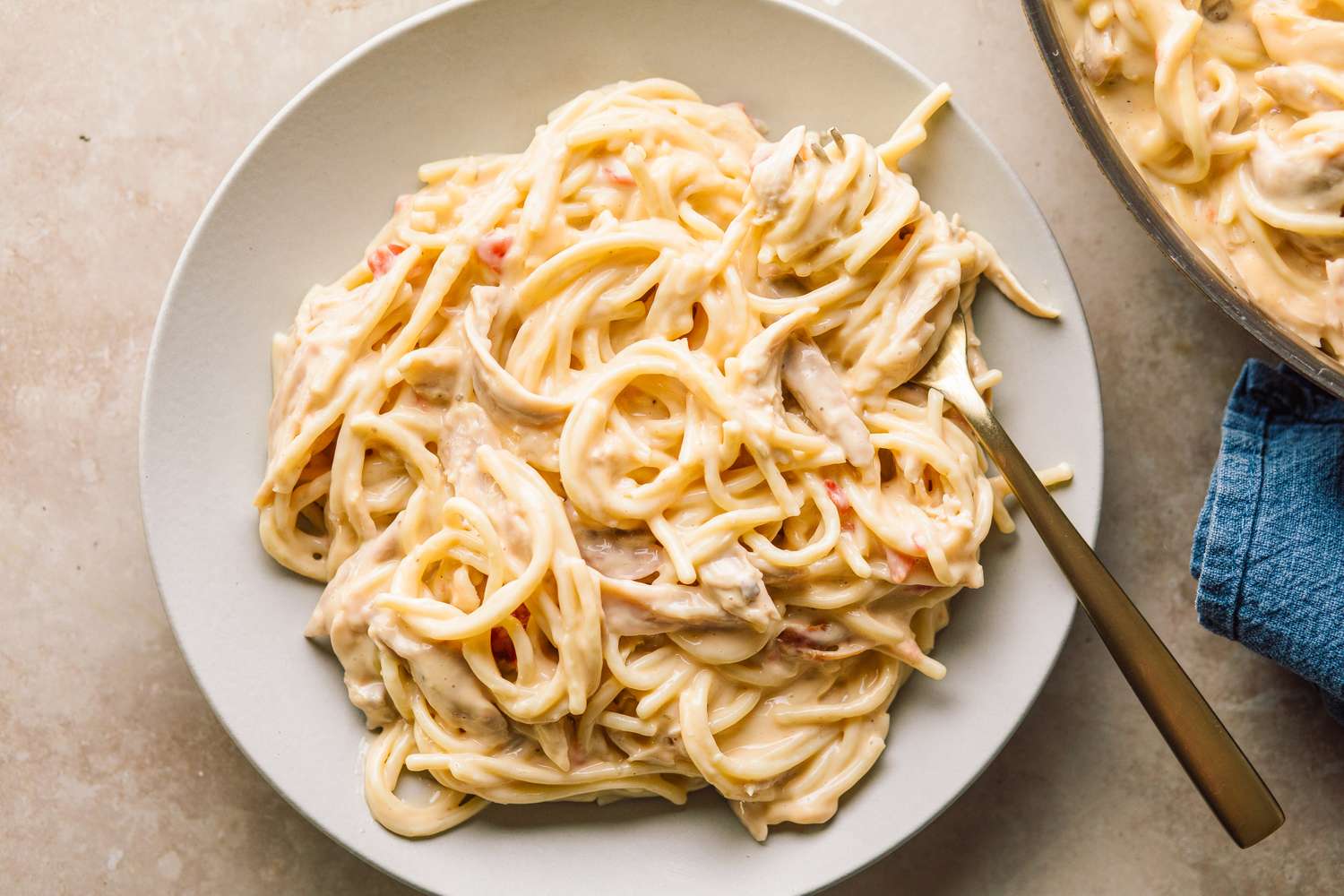Chicken Queso Spaghetti on a plate with a fork