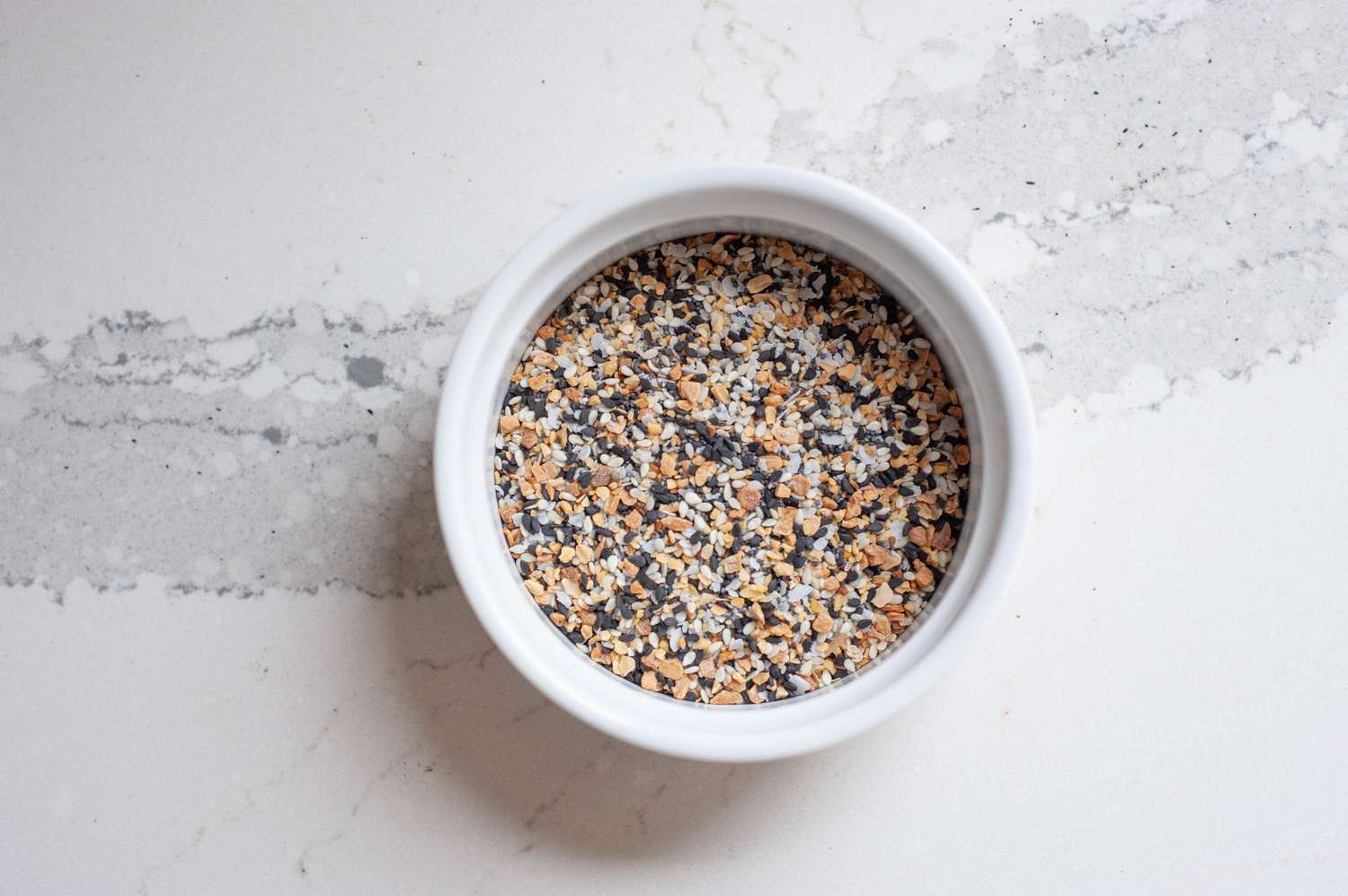 Overhead view of a ramekin of everything bagel seasoning.