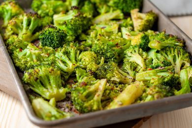 seasoned roasted broccoli florets on a sheet pan