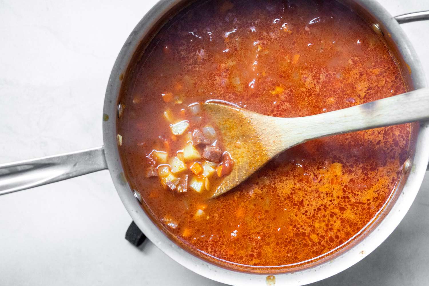 Cooked Chorizo and Chicken Stock Added to Pot with Vegetables for Shrimp and Chorizo Chowder Recipe