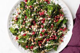 Grilled Broccolini with Lemon Tahini Dressing, Pomegranate Arils, and Pine Nuts on a Plate