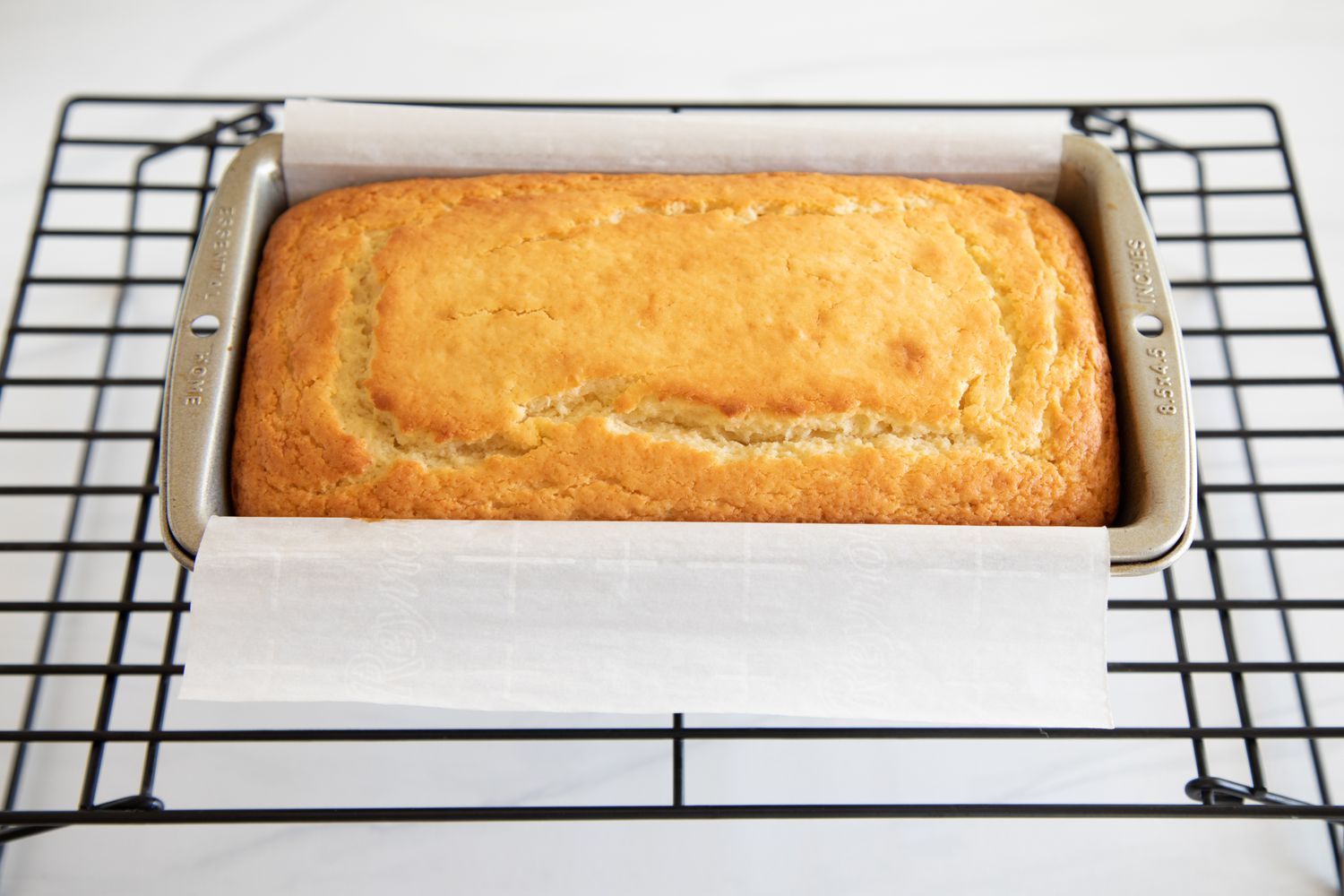The BEST Yogurt Cake You’ll Ever Eat cooling on a rack.