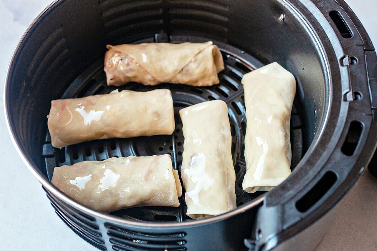 Air fryer egg rolls recipe add to fryer and brush with oil